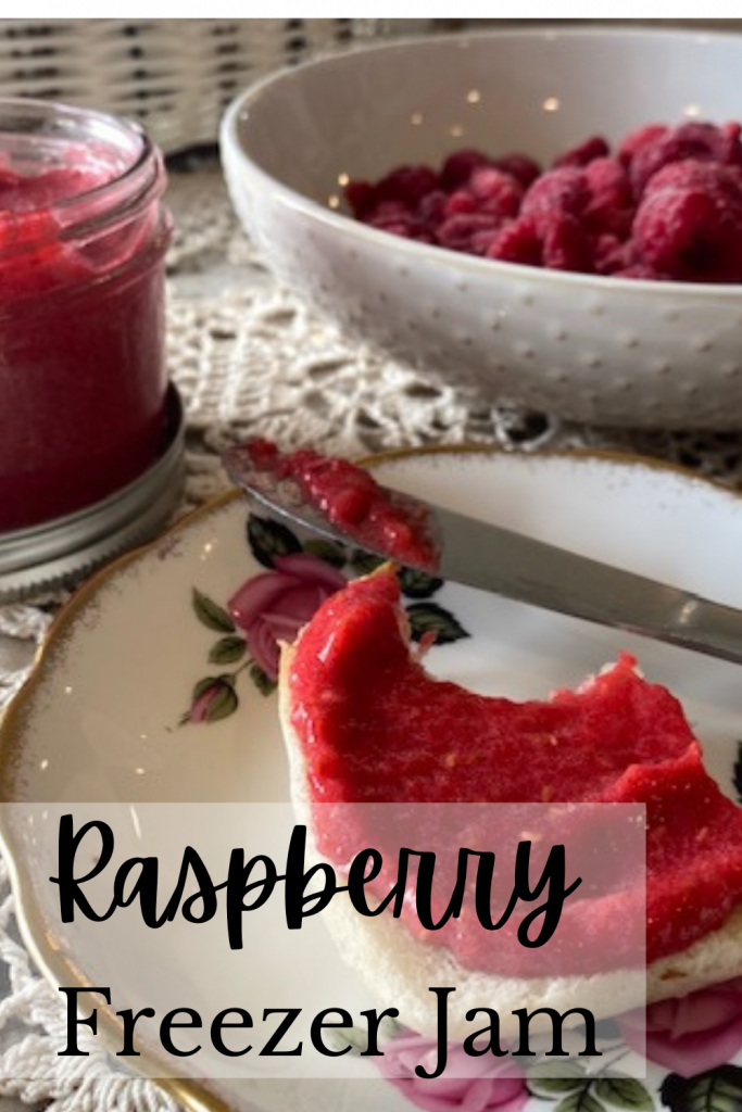 bread and raspberry jam with knife of flower plate