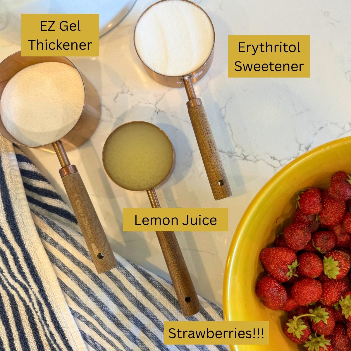 Erythritol granules, EZ gel thickener, lemon juice and strawberries labeled on counter for freezer jam