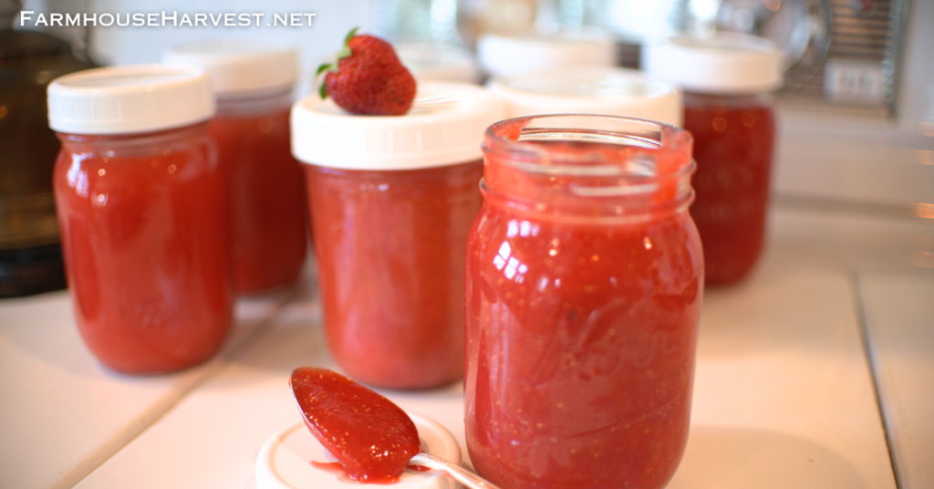 strawberry freezer jam in jars and spoon with website text