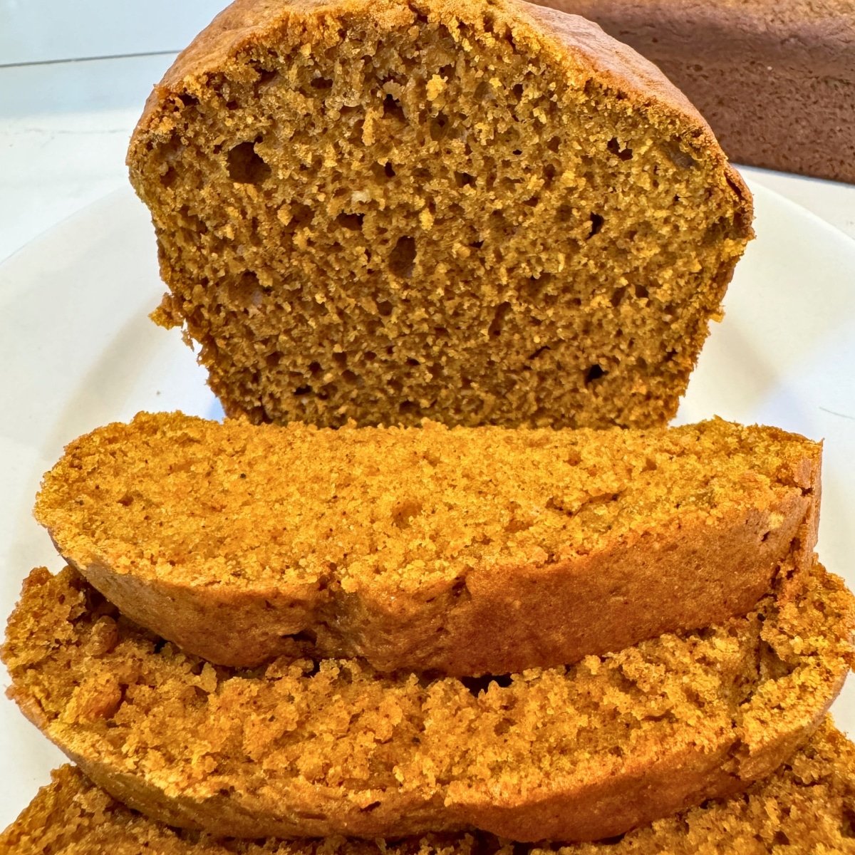 moist pumpkin bread sliced on a platter showing inside