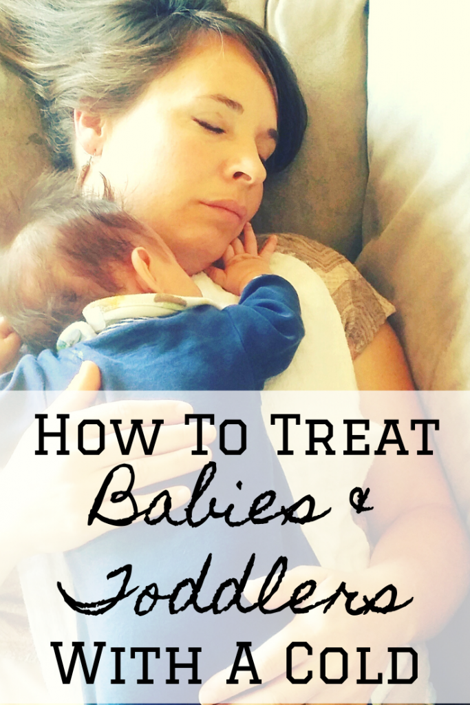 mom holding sleeping baby with cold text that says how to help babies with colds feel better 