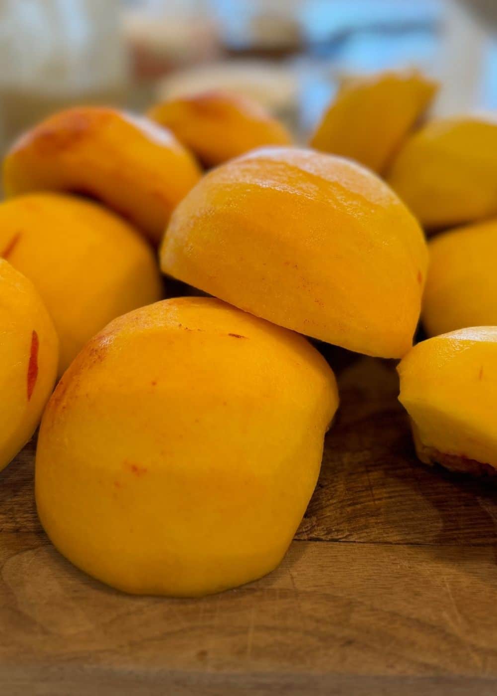 peaches for peach and pear salsa with skins off on cutting board