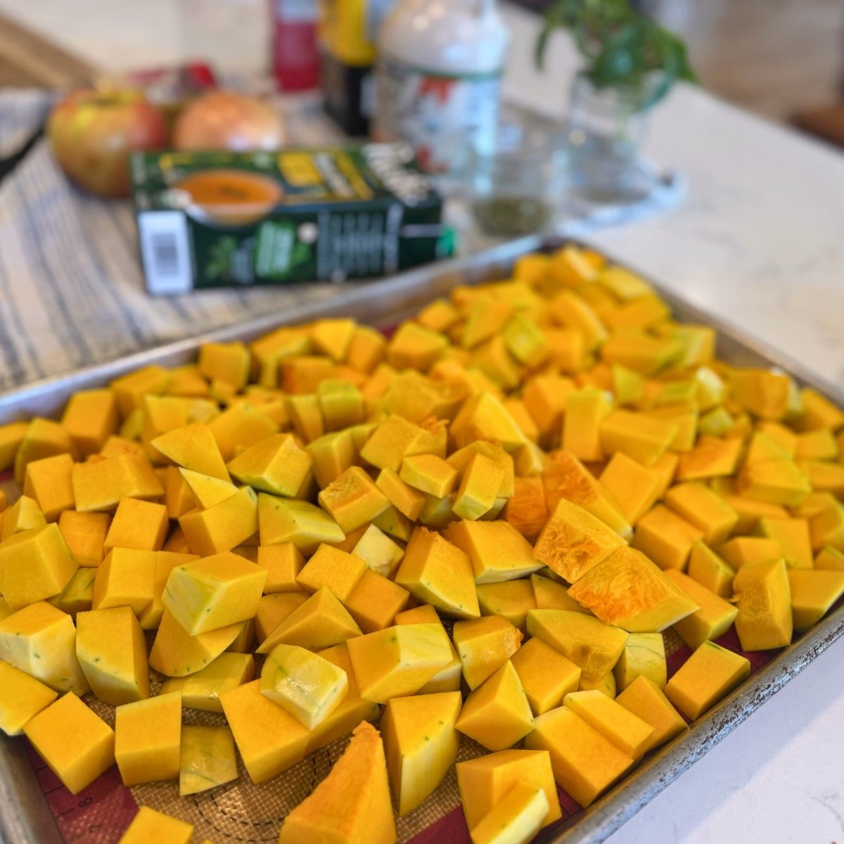 chopped butternut squash on roasting pan