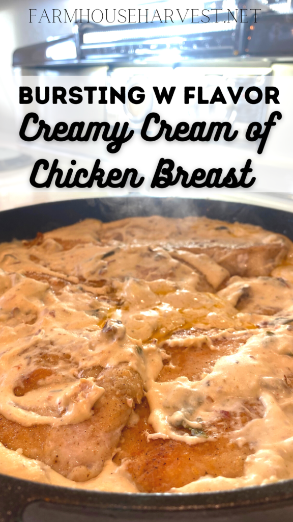 seared chicken breasts simmering in creamy sauce in a cast iron skillet on the stove. With text