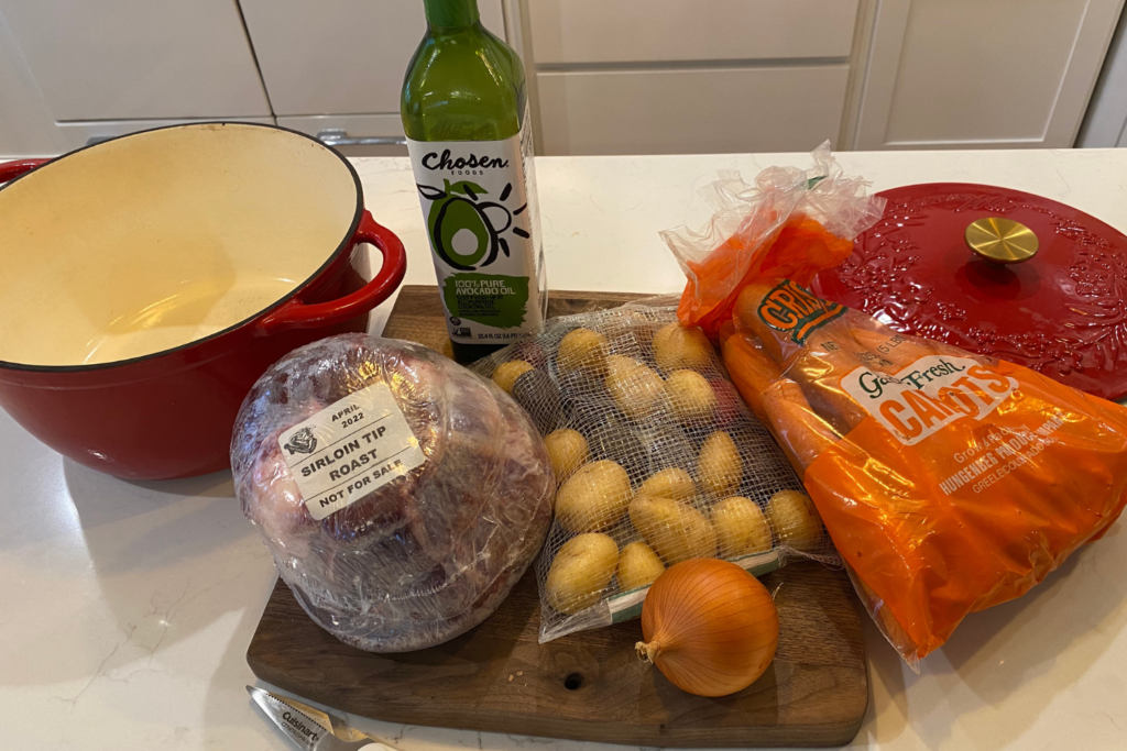 sirloin tip roast ingredients potatoes carrots roast onion oil and cutting board