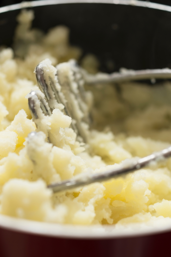 mashing potatoes with hand masher