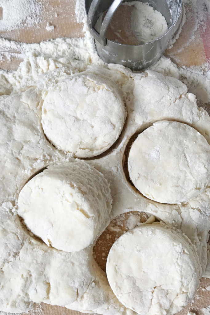  cutting biscuits out of sourdough biscuit dough. 