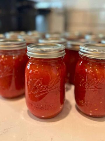 home canned crushed tomatoes in pint jars on counter