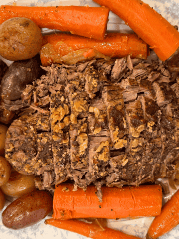 slow cooker rump roast with potatoes carrots and onions on a platter