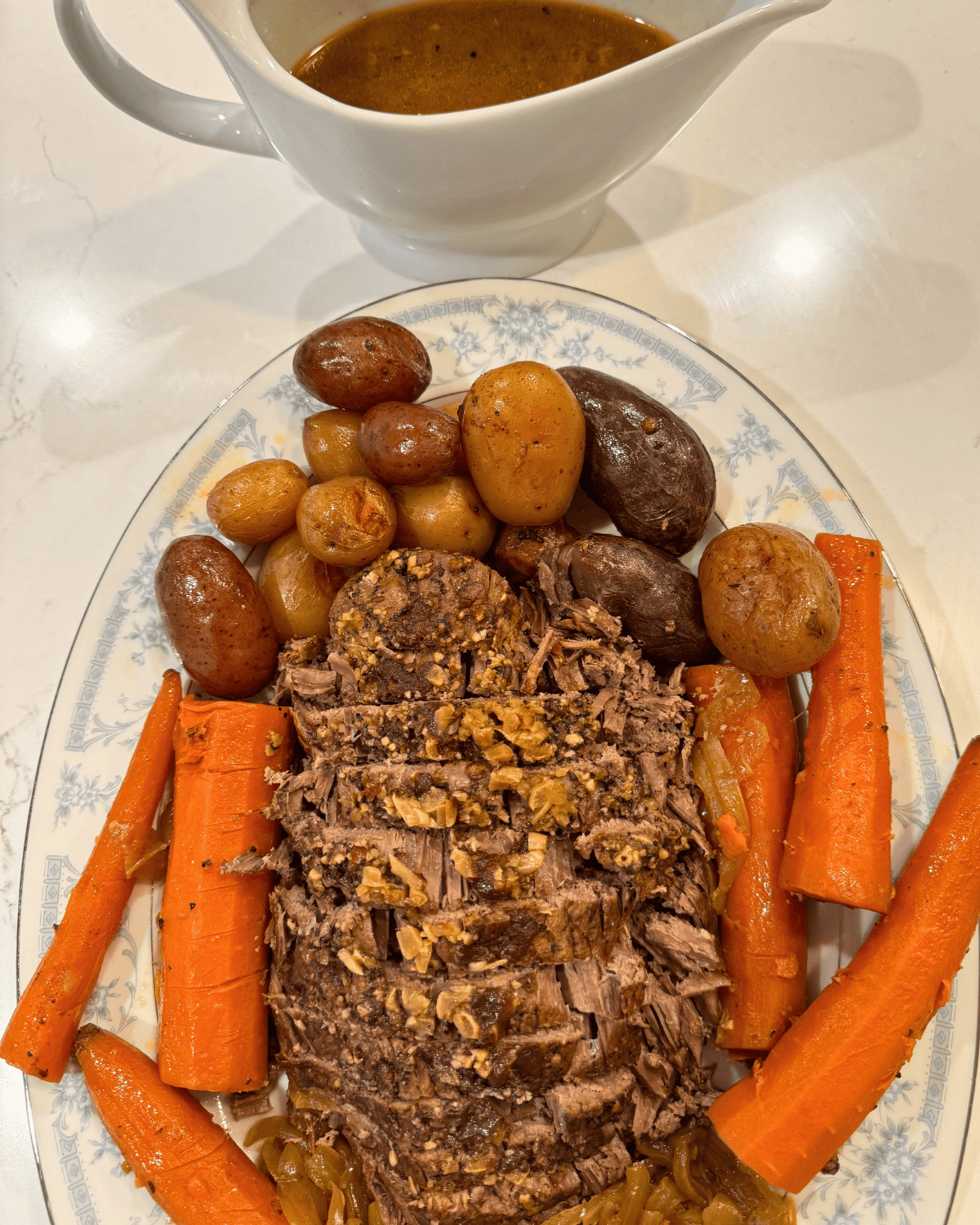 slow cooker rump roast sliced with carrots potatoes and onion on platter