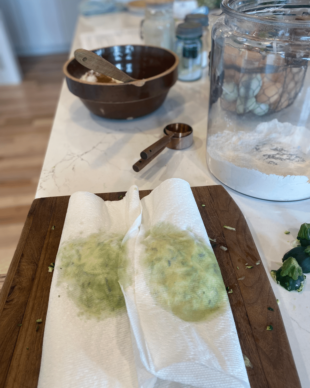 pressing zucchini to squeese out water in a clean towel