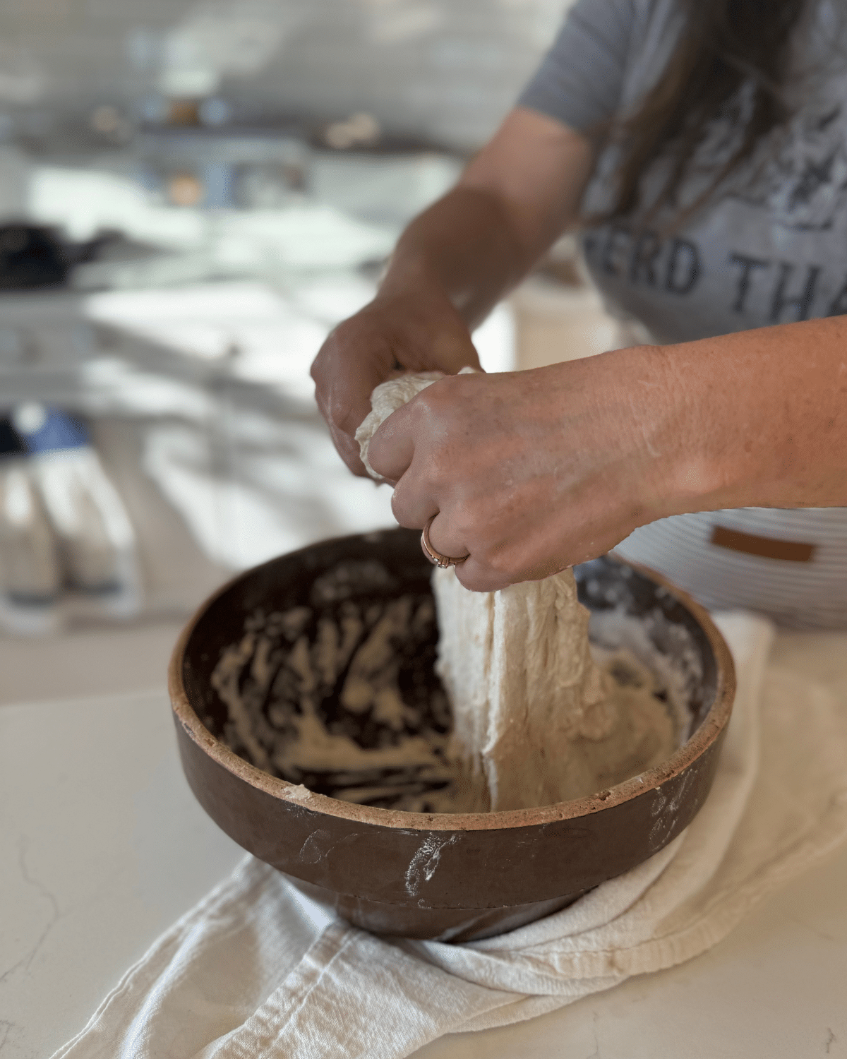 stretching sourdough bread dough on another side