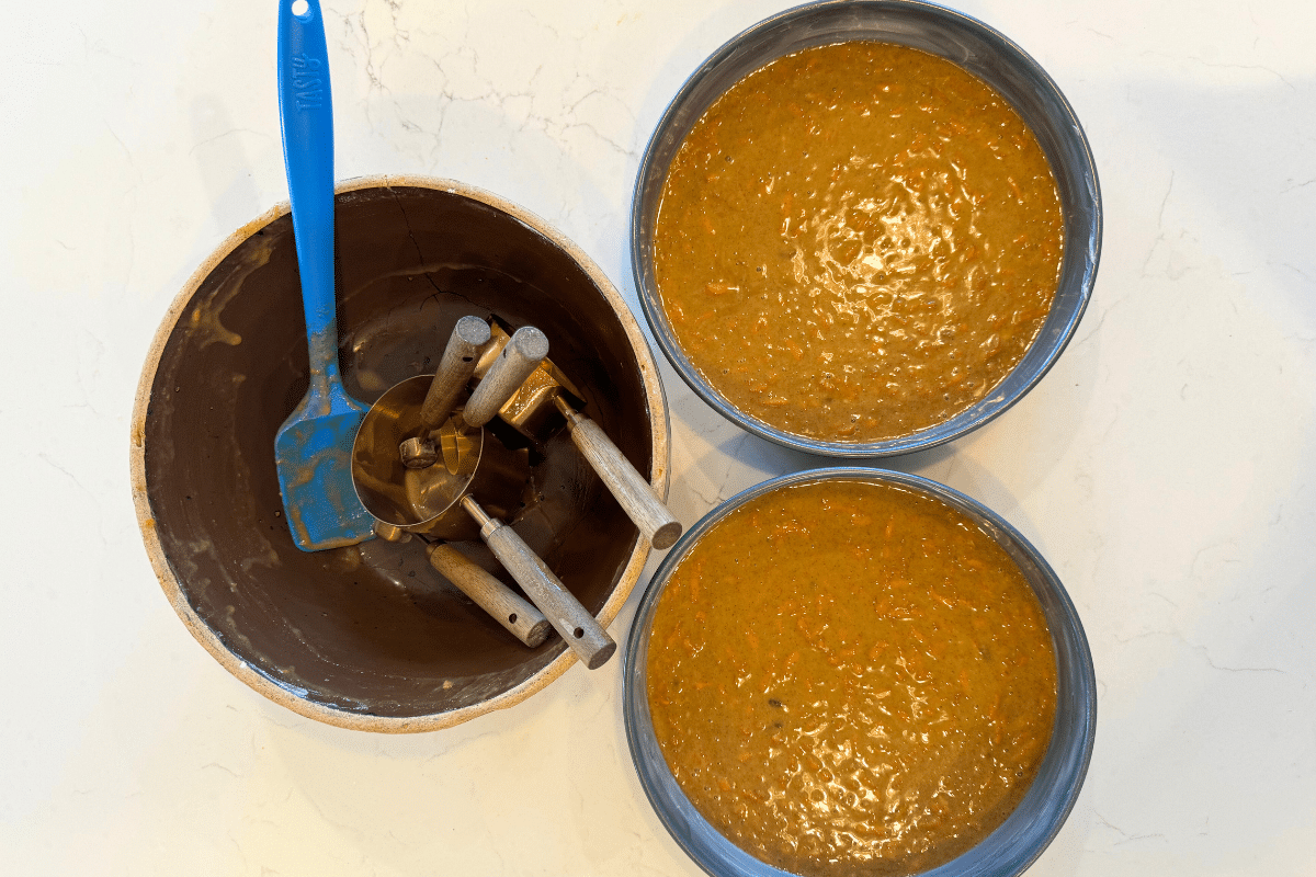 sourdough carrot cake batter in 9x9 round cake pans