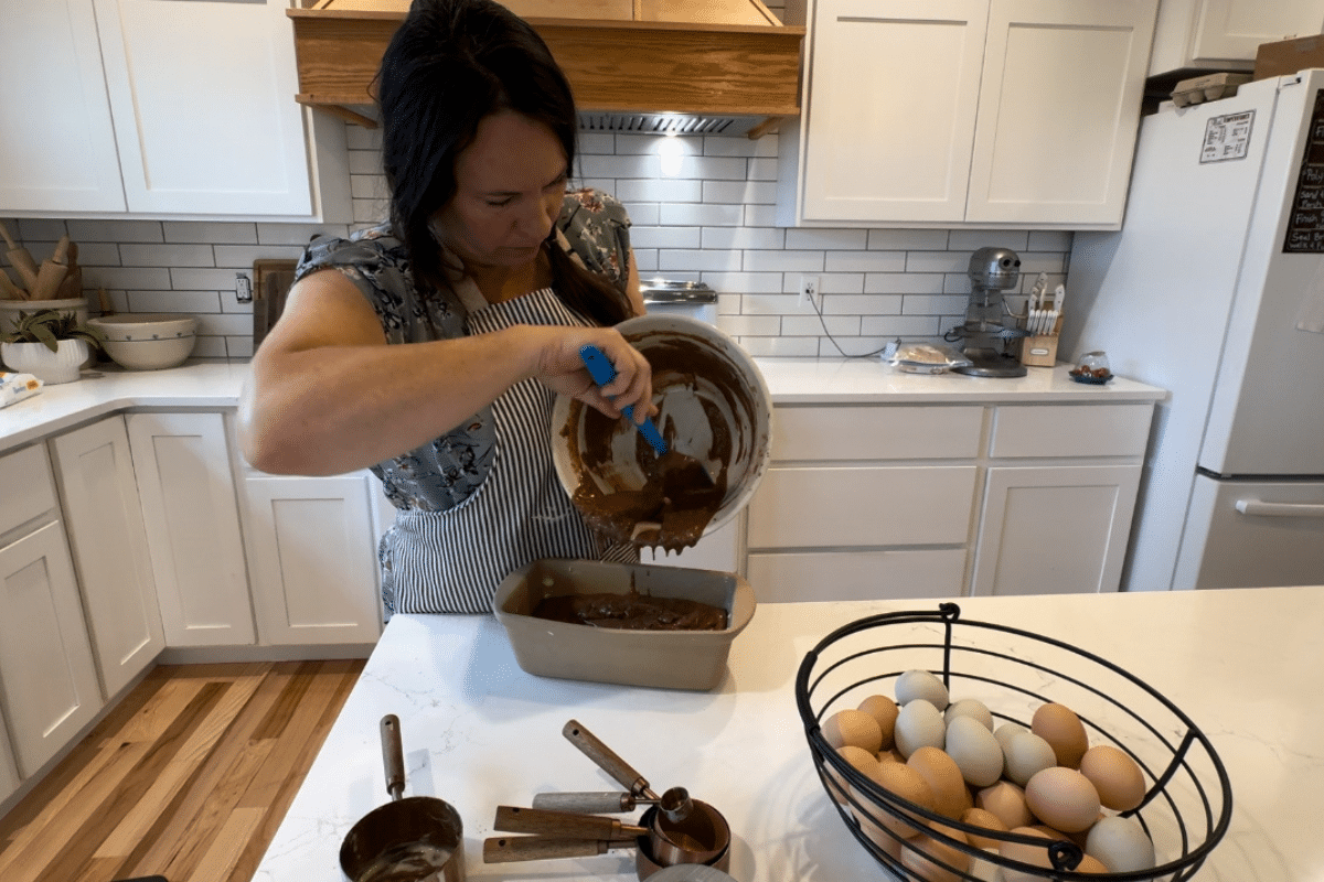 making sourdough chocolate banana bread pouring batter into pan