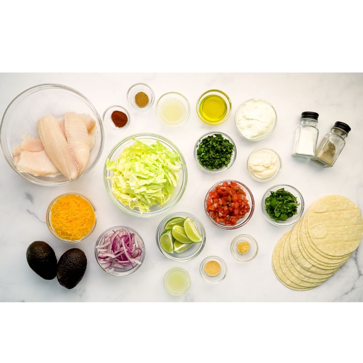 fish, spices, cabbage, tortillas, sourcream, mayo, avocado. onion, tomatoes, pico de gallo, cheese lime, cilantro
