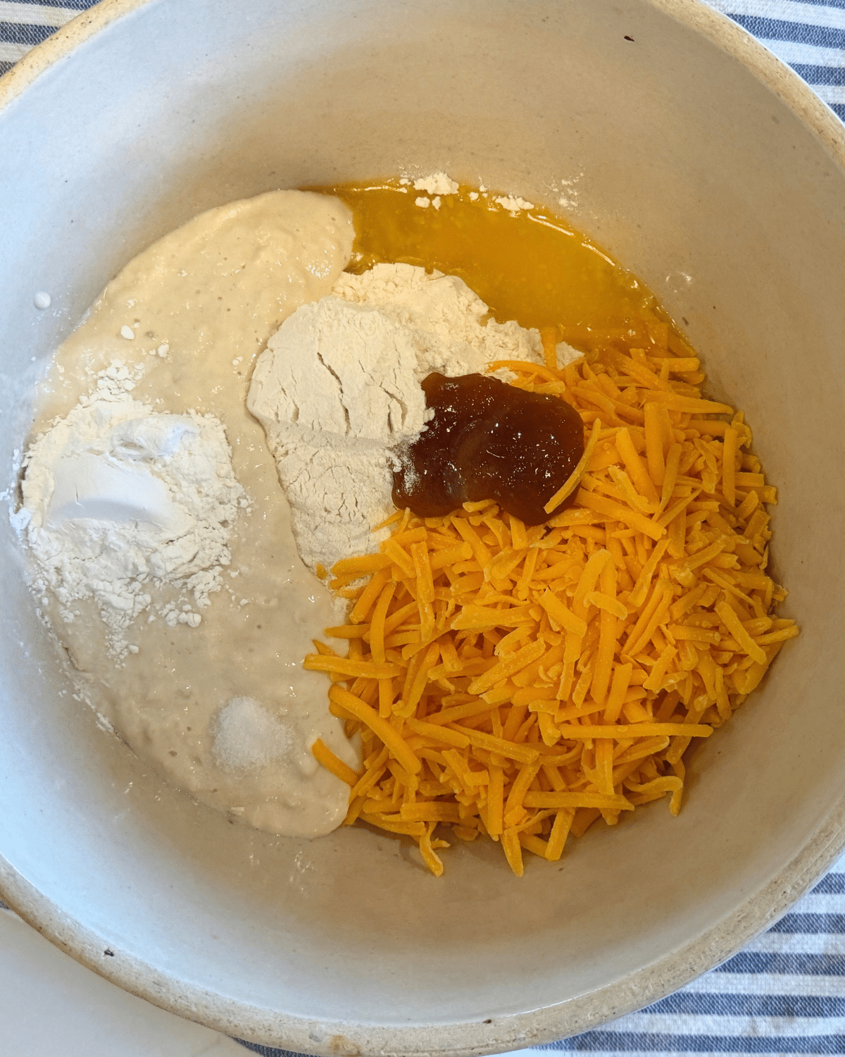 all sourdough hceddar biscuit ingrendets in a bowl