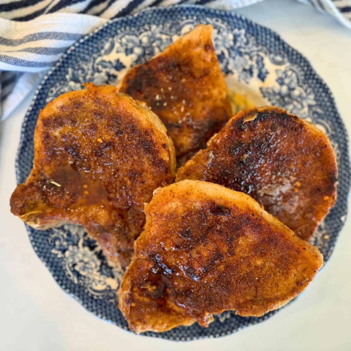 pan seared pork chops on a blue plate