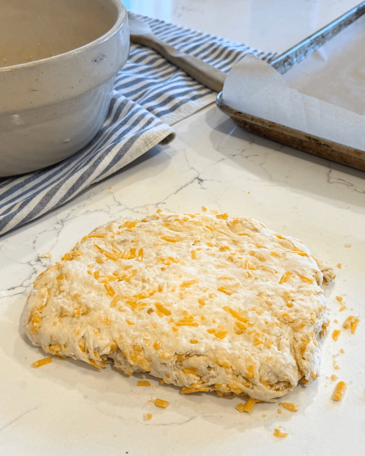 rolling, more like ppatting out sourdough cheddar biscuit dough