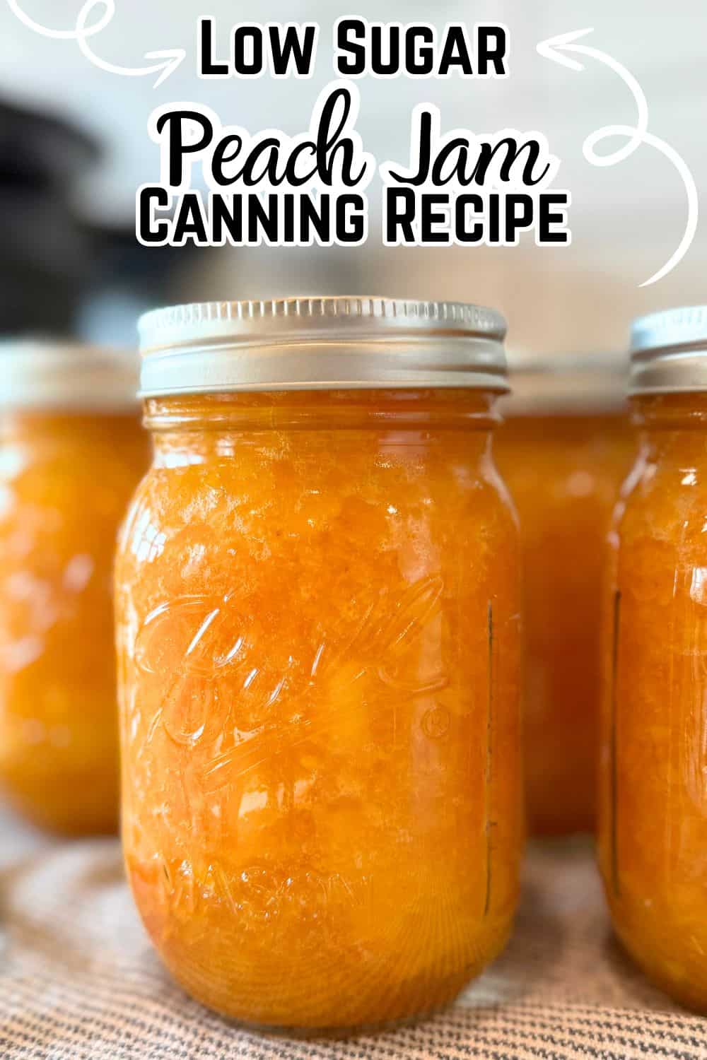 canned peach jam in jar on towel on counter with text