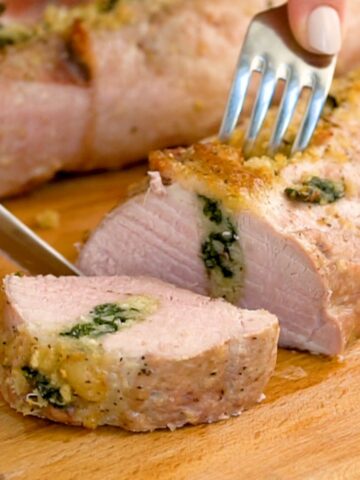 stuffed Pork Loin Sliced on a cutting board