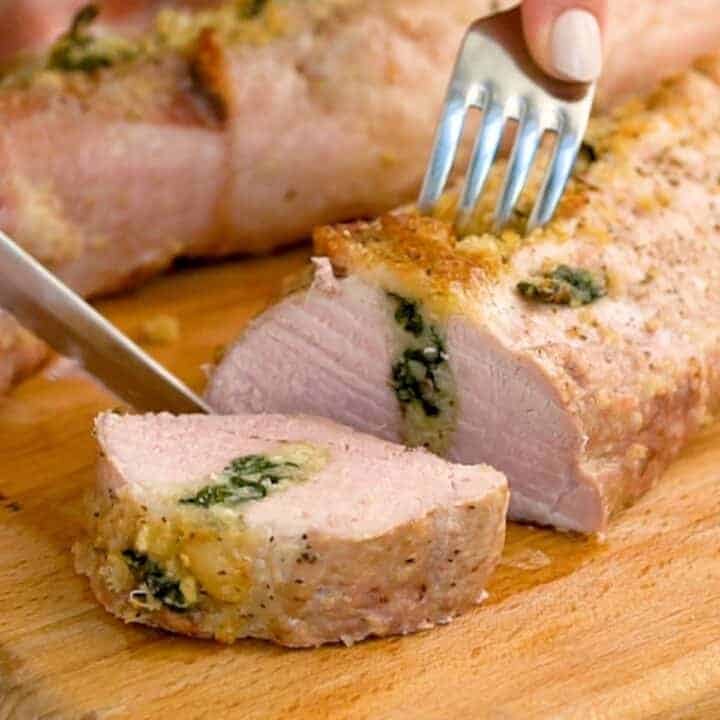 stuffed Pork Loin Sliced on a cutting board