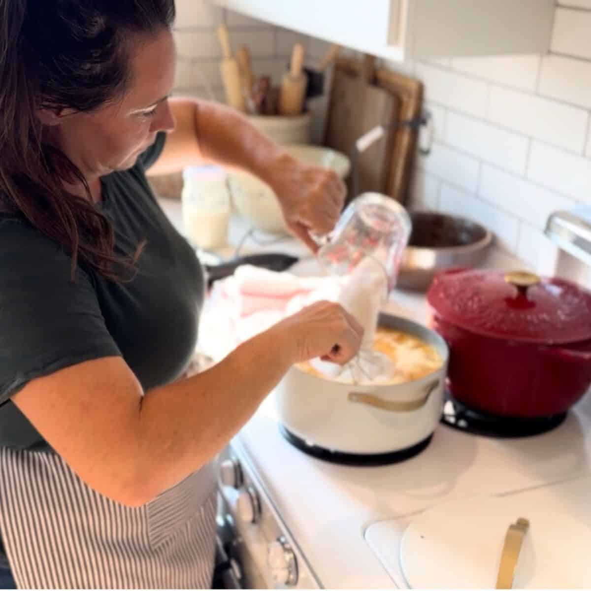 add sugar and pectin to mashed peaches in pot on stove and whisking