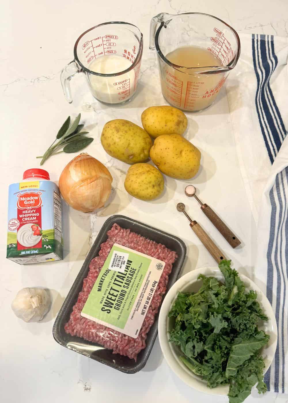 ingredients for zuppa toscana: broth, milk, cream, yukon gold potatoes, sage, garlic, onion, Italian sausage, salt, pepper and kale