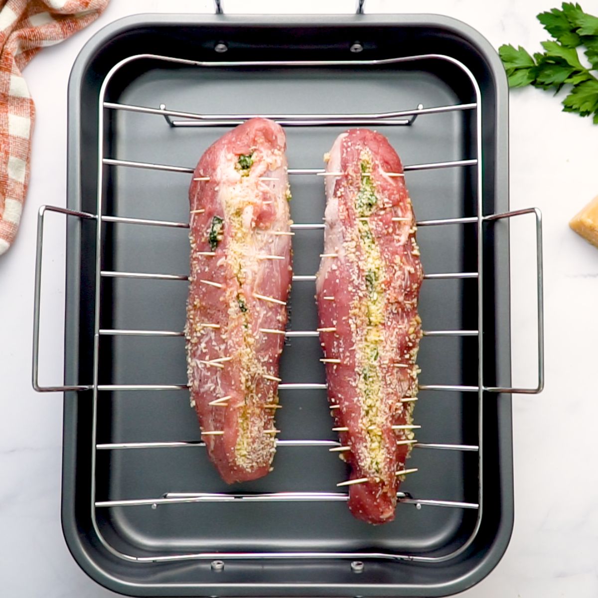 roasting stuffed pork loin in roasting pan with a roasting rack