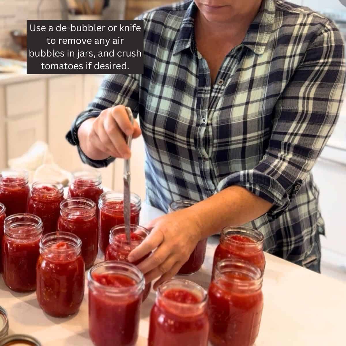 use a de-bubbler or knife to remove air bubbles in jars, and crush tomatoes if desired