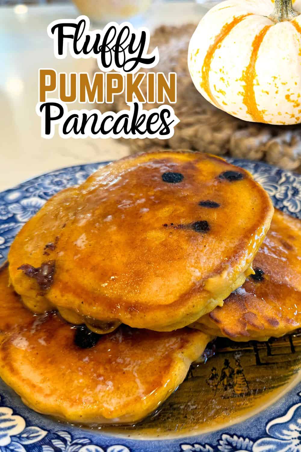 fluffy pumpkin pancakes with chocolate chips with a pumpkin and text