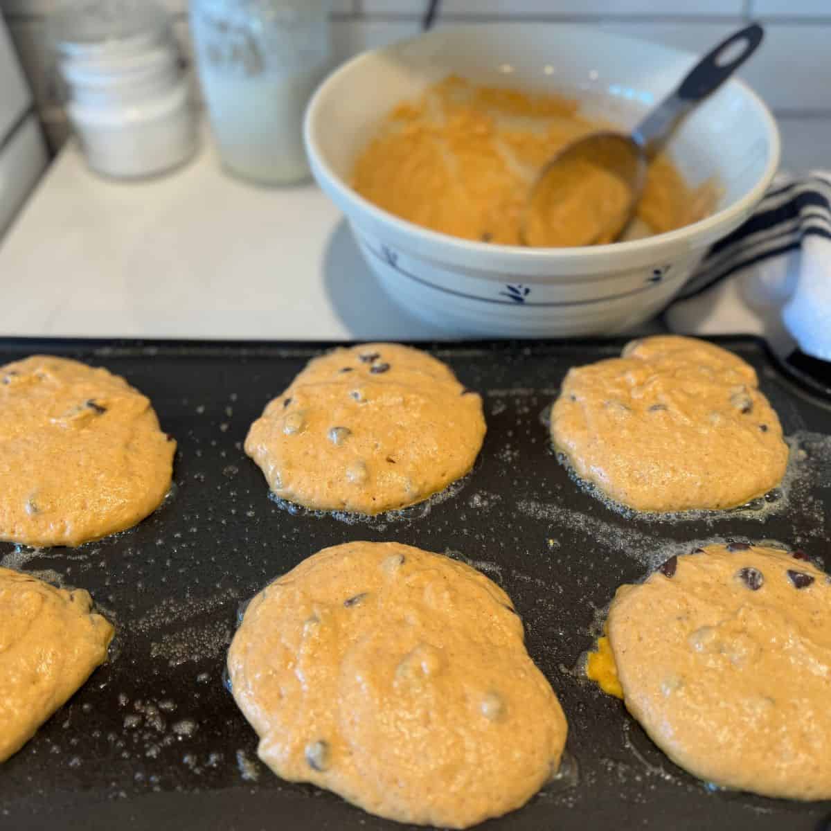 batter scooped out onto hot griddle cooking