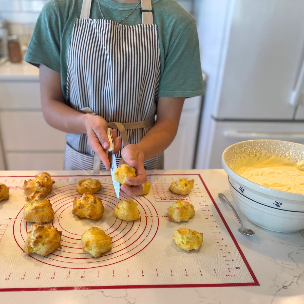 remove tops of cream puff pastries to hollow them out