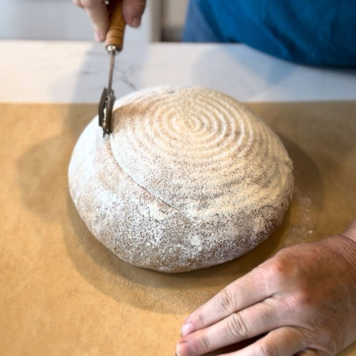 score on parchment paper, place in preheated dutch oven. and bake