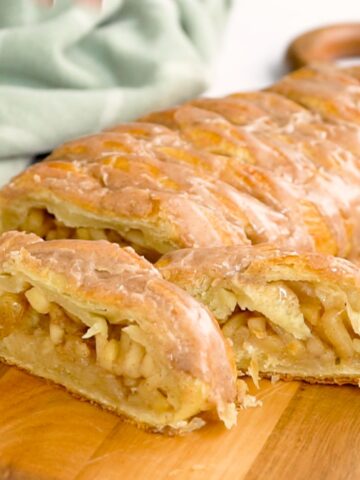 apple strudel recipe glazed and sliced on a cutting board