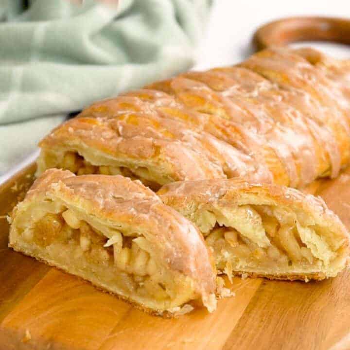 apple strudel recipe glazed and sliced on a cutting board