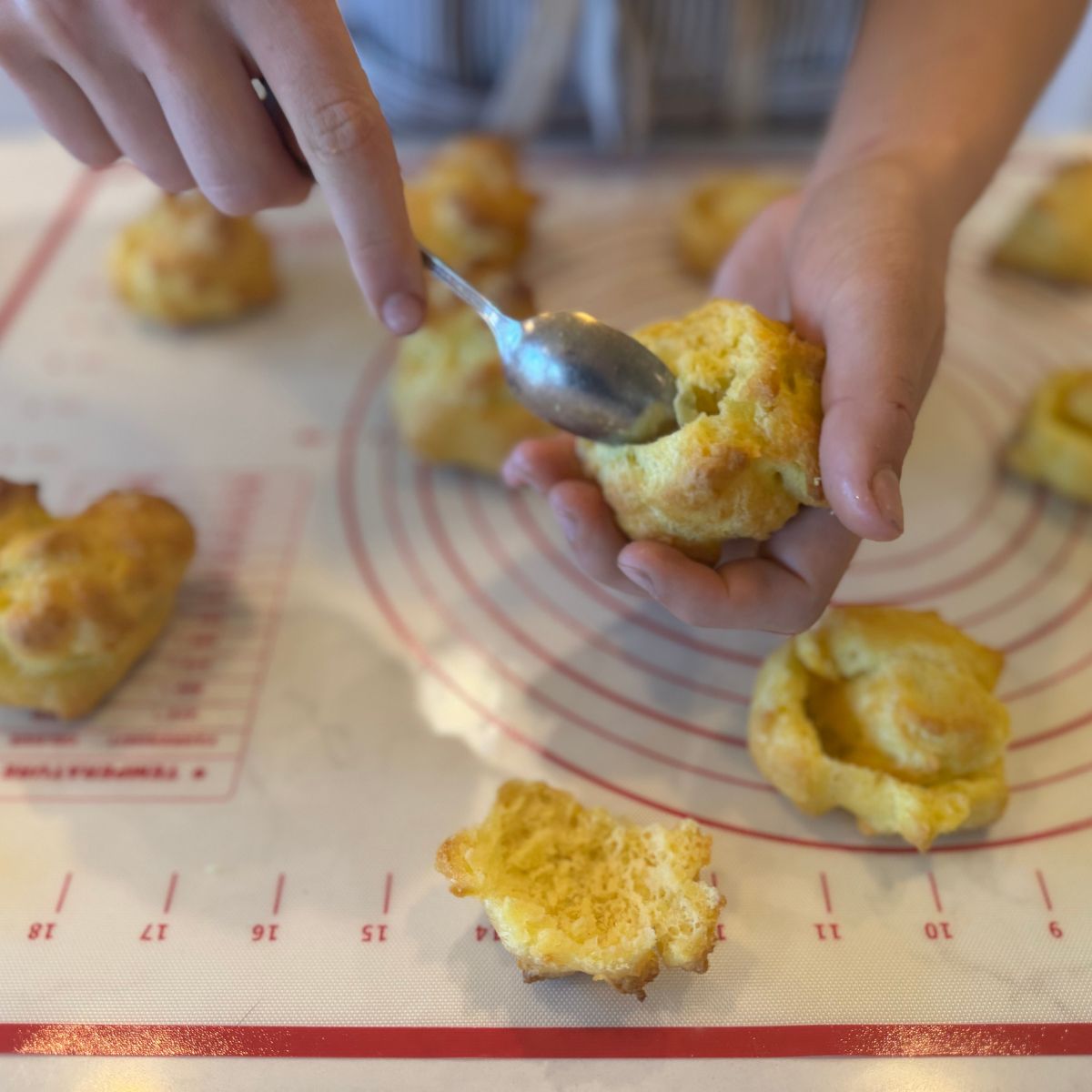 use a small spoon to hollow out cream puffs