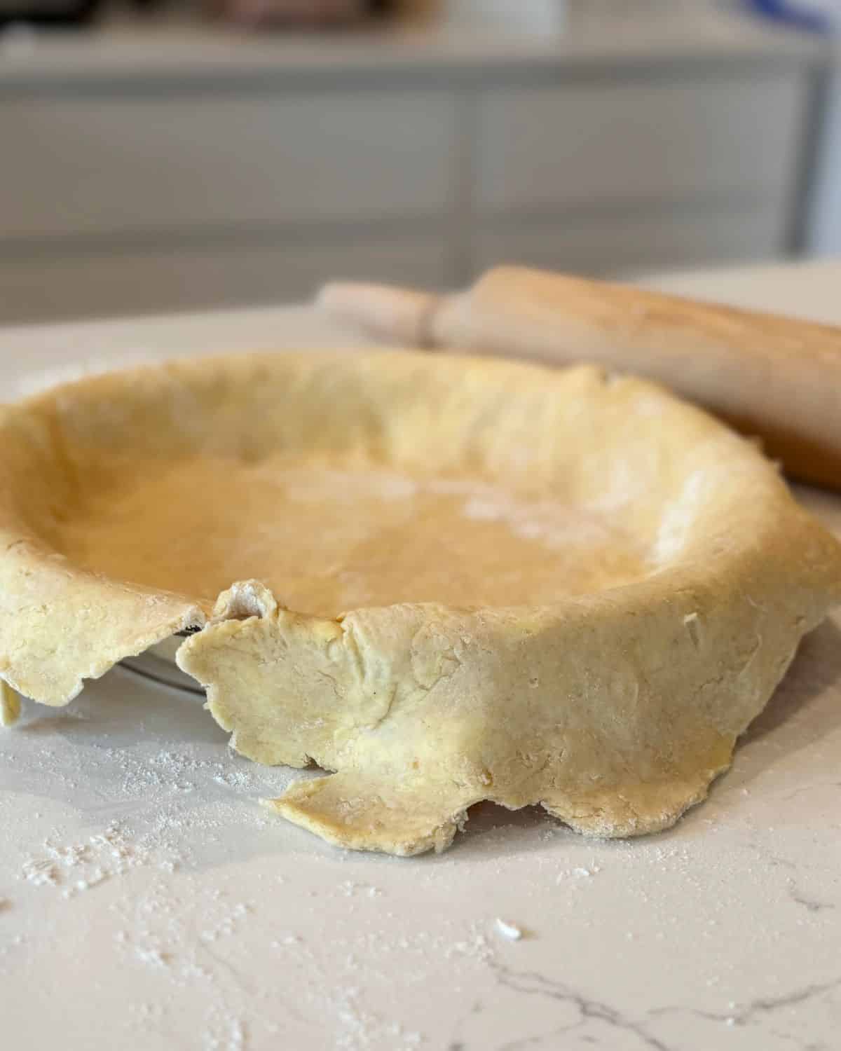 flaky pie crust recipe dough rolled out into pie pan