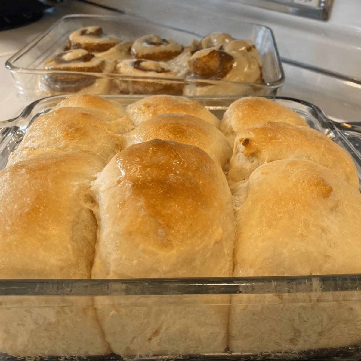 soft sourdough rolls in baking dish on stove top
