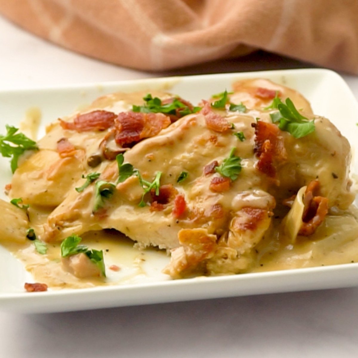 bite of creamy chicken skillet with bacon and sun dried tomatoes