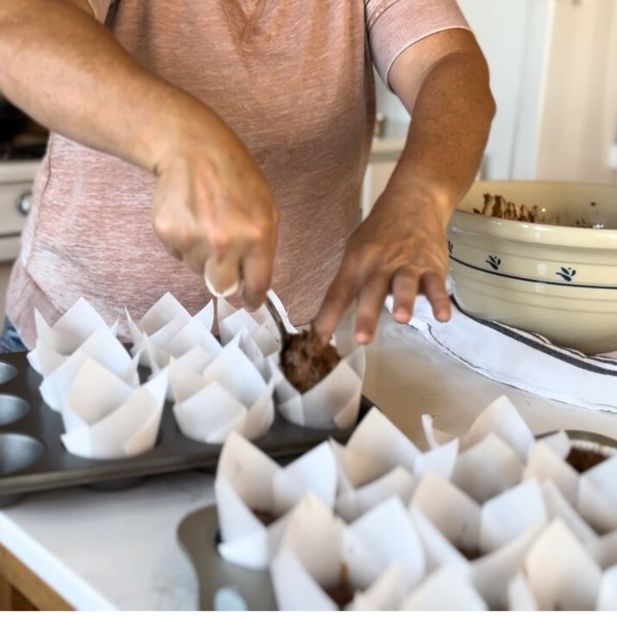 me filling lined muffin tins