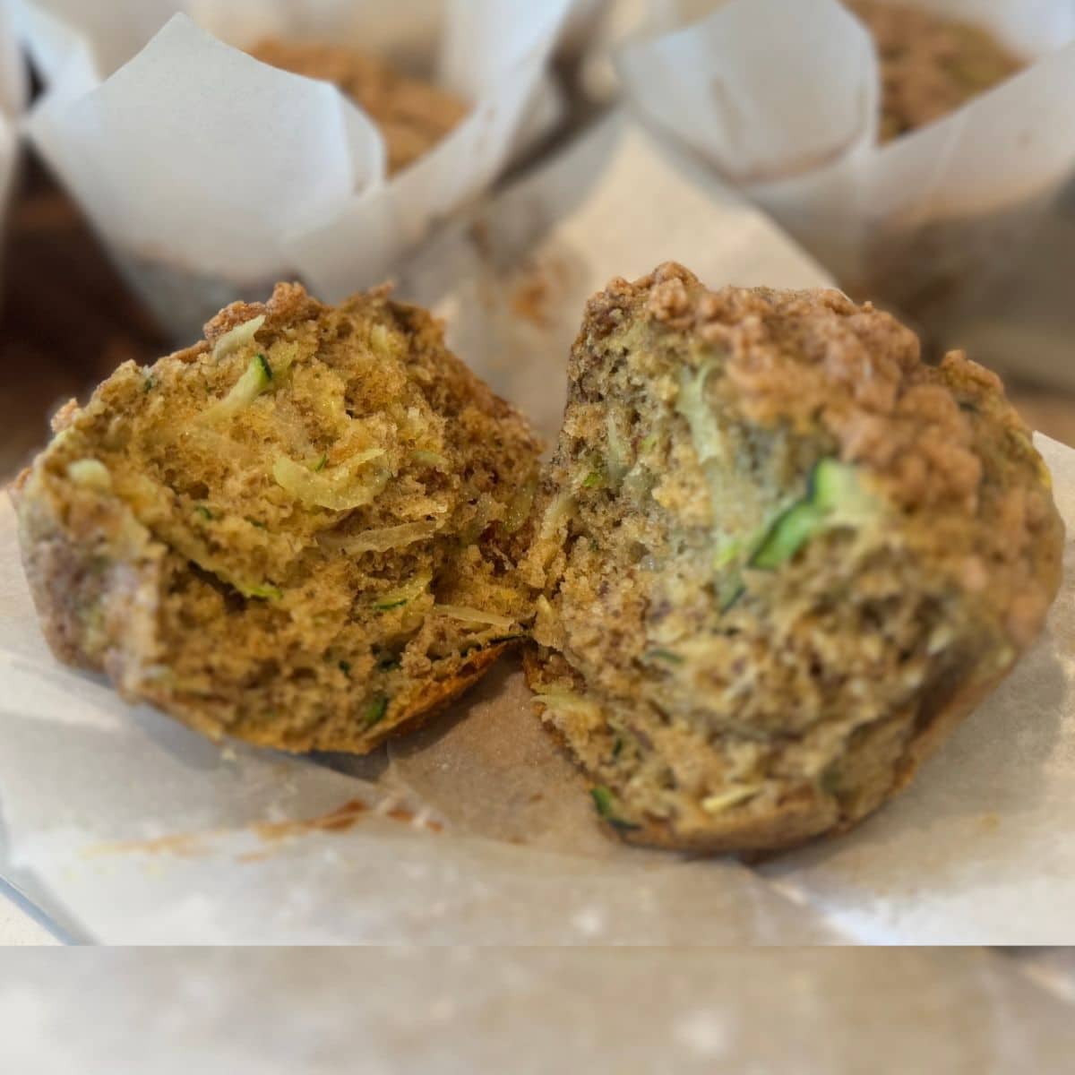 sourdough zucchini muffins torn open up close to show texture