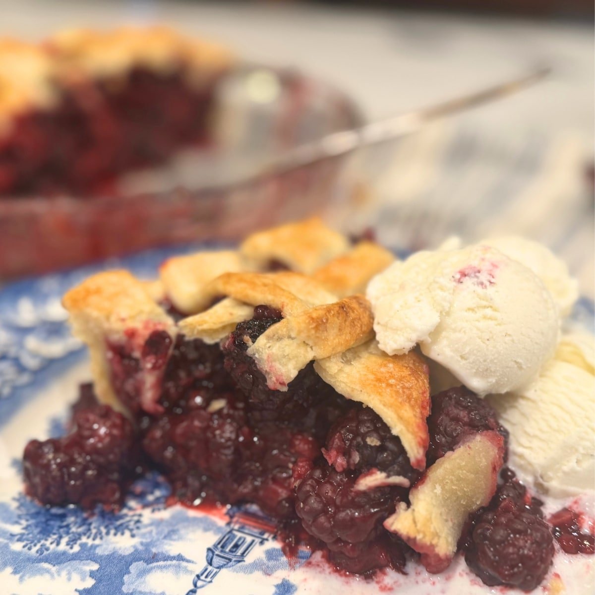 fresh Blackberry Pie on homemade flaky crust with vanilla ice cream