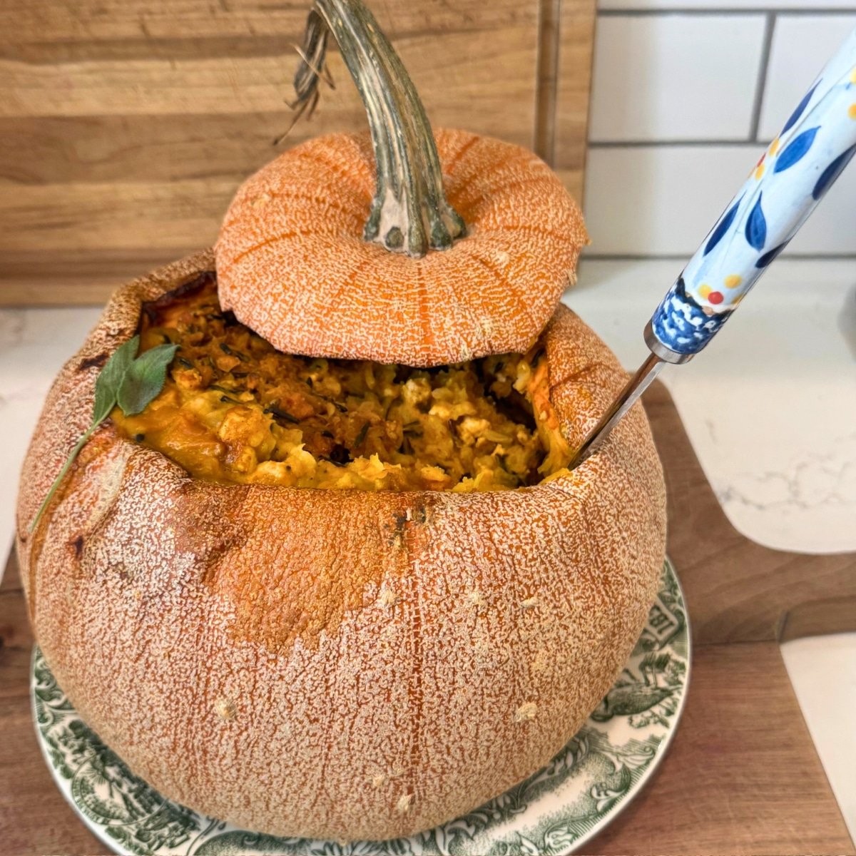 Turkey & Wild Rice Stuffed Pumpkin - Dinner in a Pumpkin on cutting board with a serving spoon