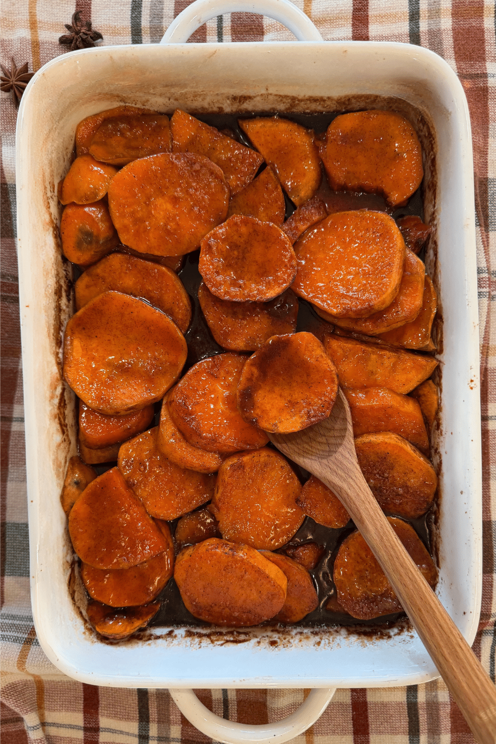 baked candied yams with caramel sauce galze in white baking dish