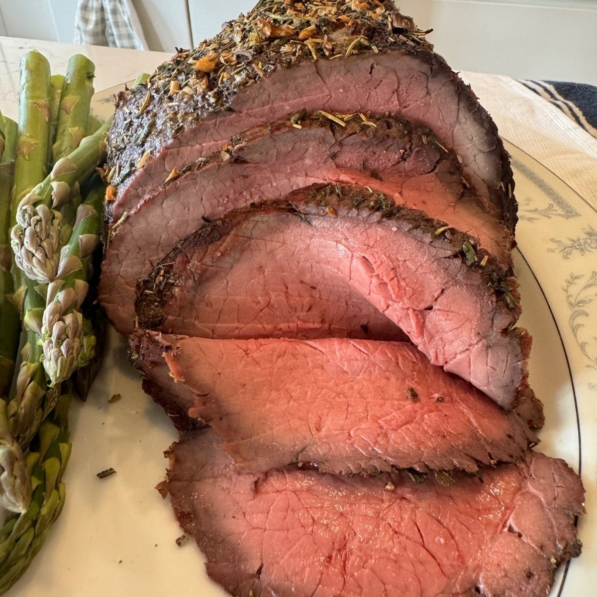 oven seared top round roast sliced on platter