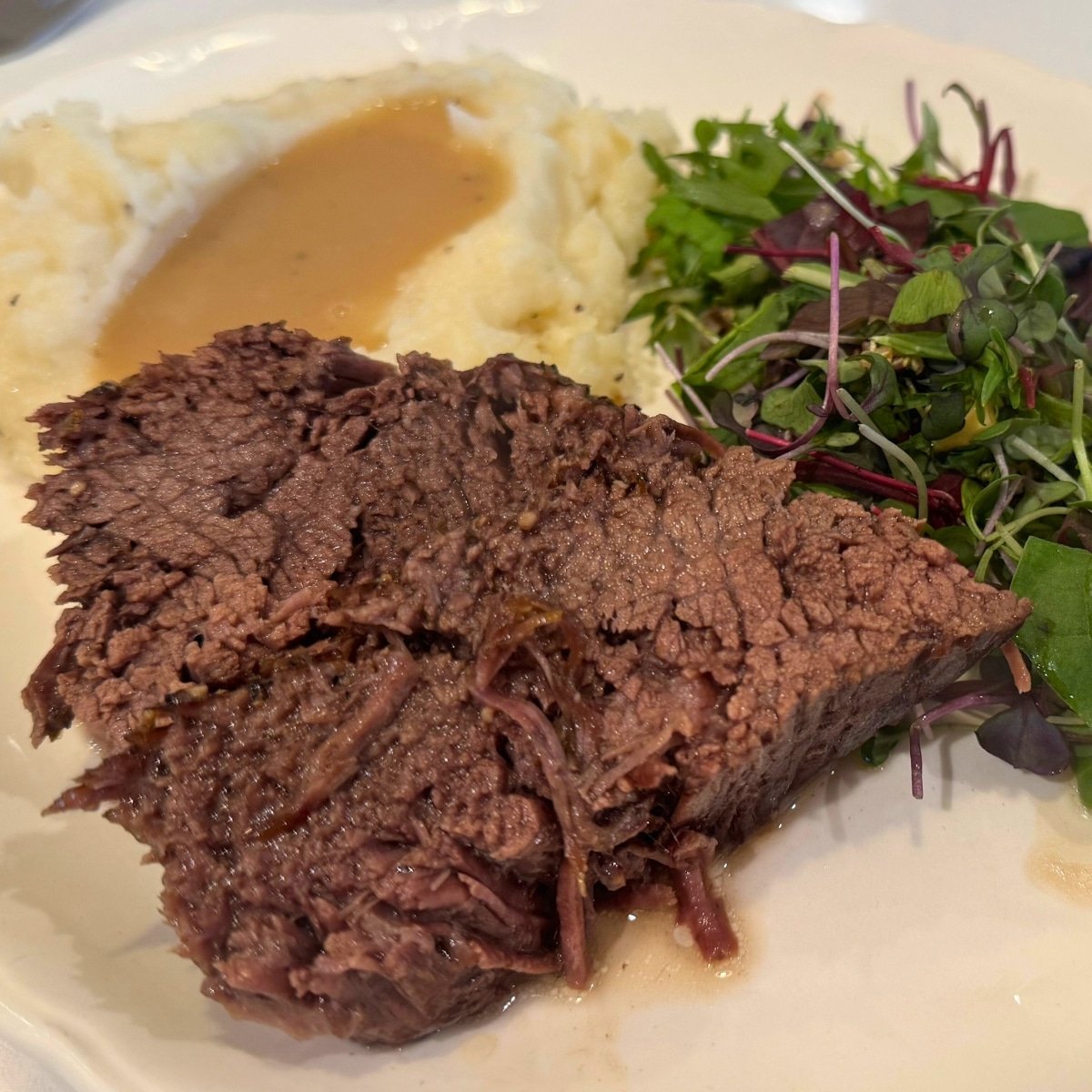 Tender Under Blade Roast in the Dutch Oven served with mashed potatoes and gravy and a green salad