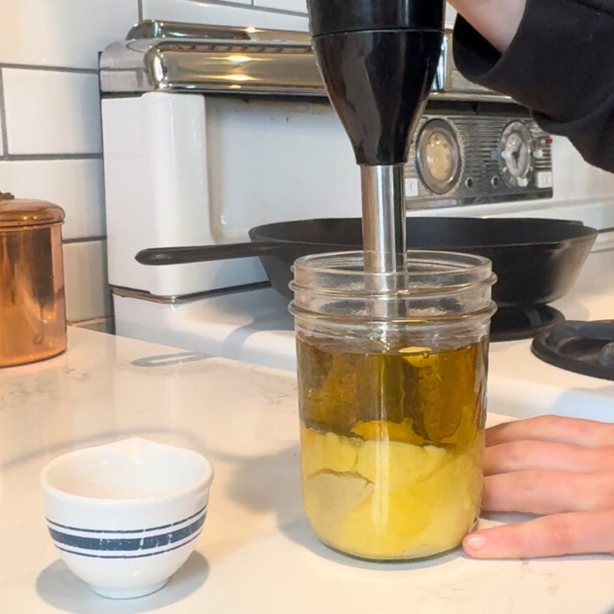blending homemade avocado oil mayonnaise with immersion blender