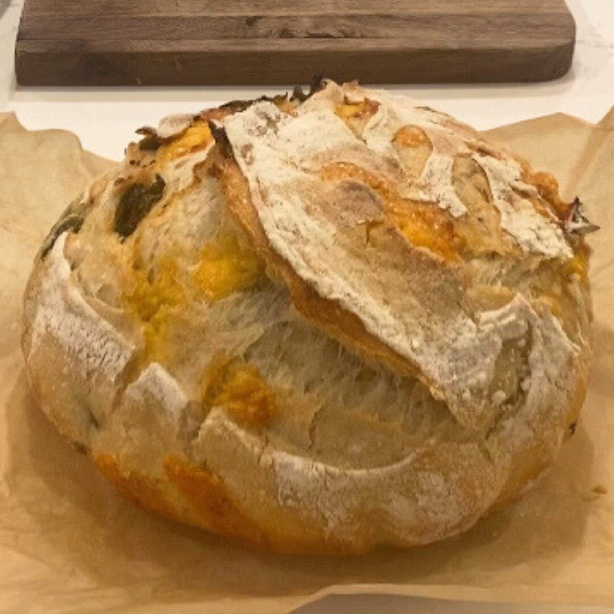 jalapenno cheddar sourdough bread on parchment paper