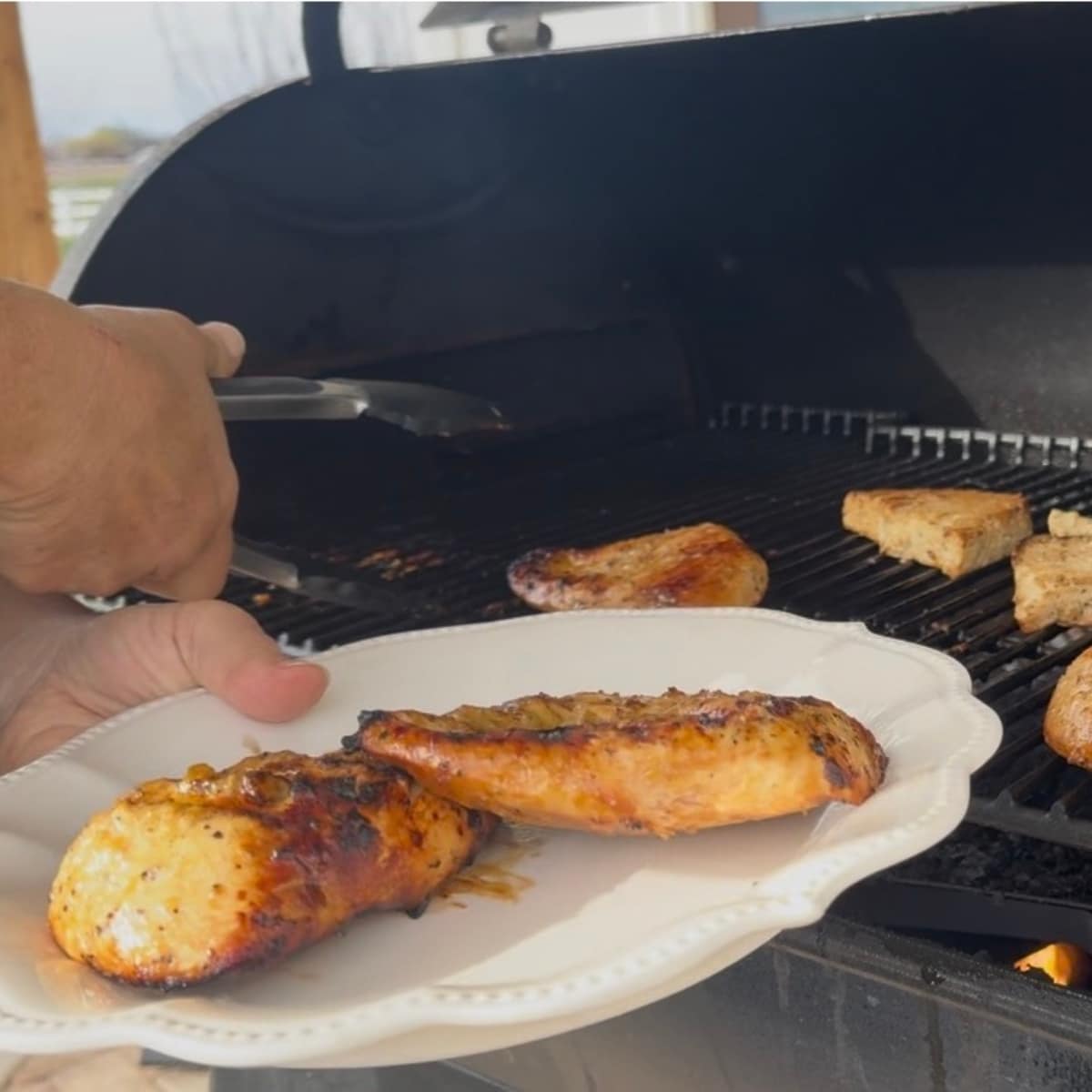removing grilled chicken from the traeger grill