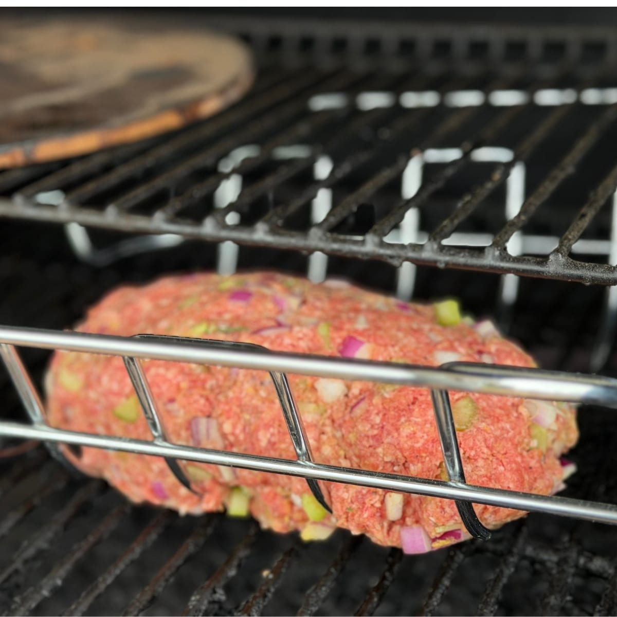 Meatloaf in Grilling rack placed on the grill in the grillin rack for easy trasport